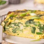 Cottage cheese egg bake with spinach, peppers, and eggs, served in a casserole dish.